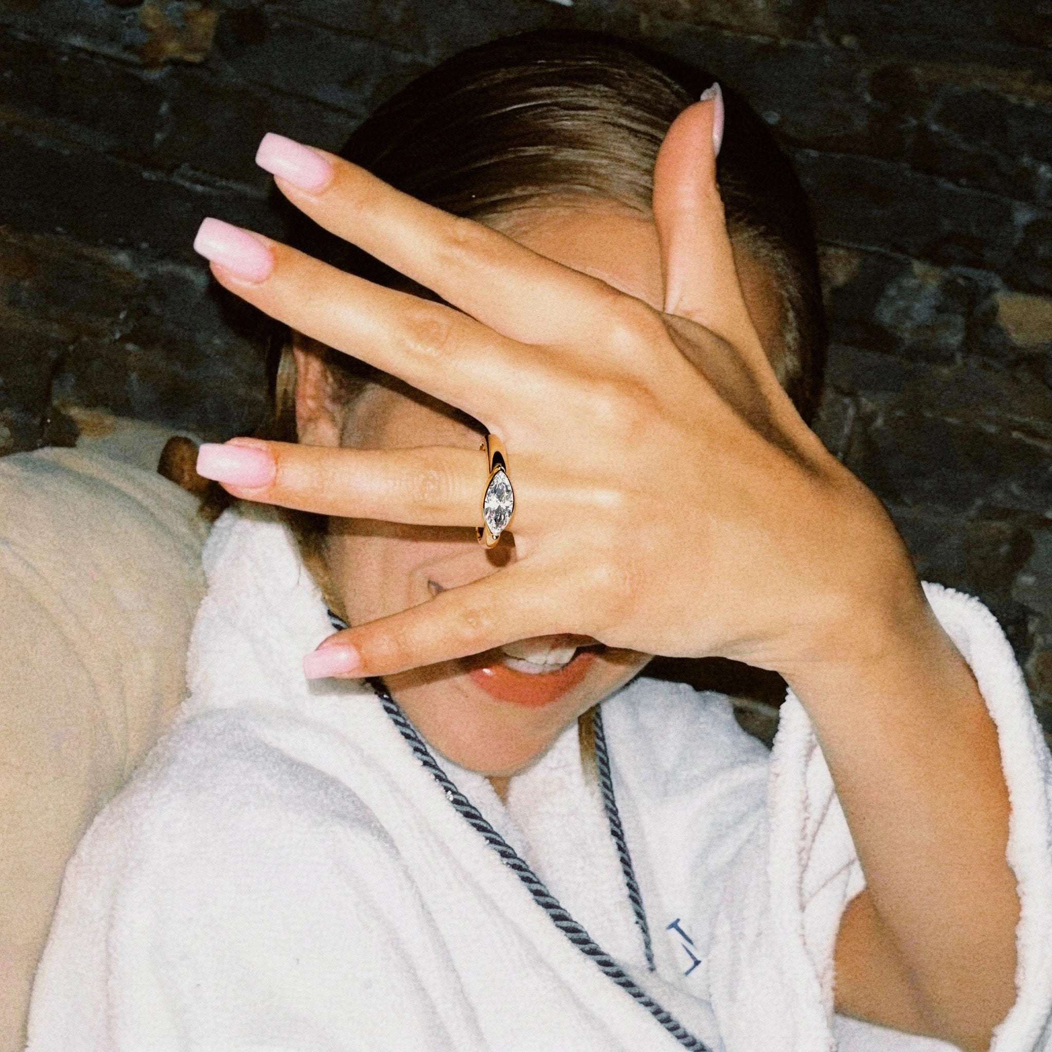 Anillo de compromiso corte marquesa sobre mano en fotografía lifestyle con flash