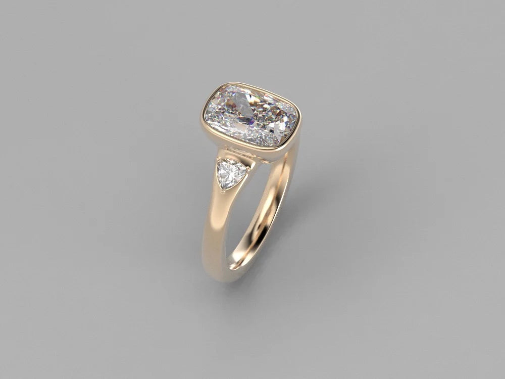 Anillo trilogía con diamante lab-grown de corte cojín elongado en oro amarillo 18k hecho a medida por BRAVORA