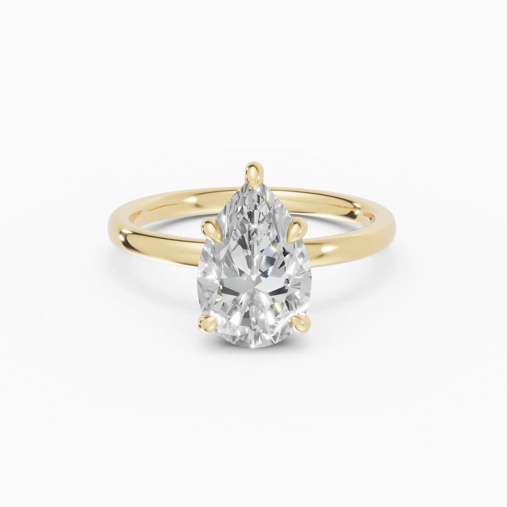 Anillo de compromiso THEIA pera solitario halo escondido en oro amarillo 18k